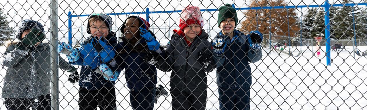 Children playing outside in their winter gear